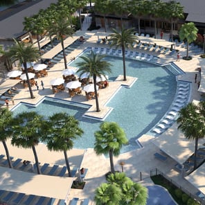 Aerial view of large resort style pool with lounge chairs