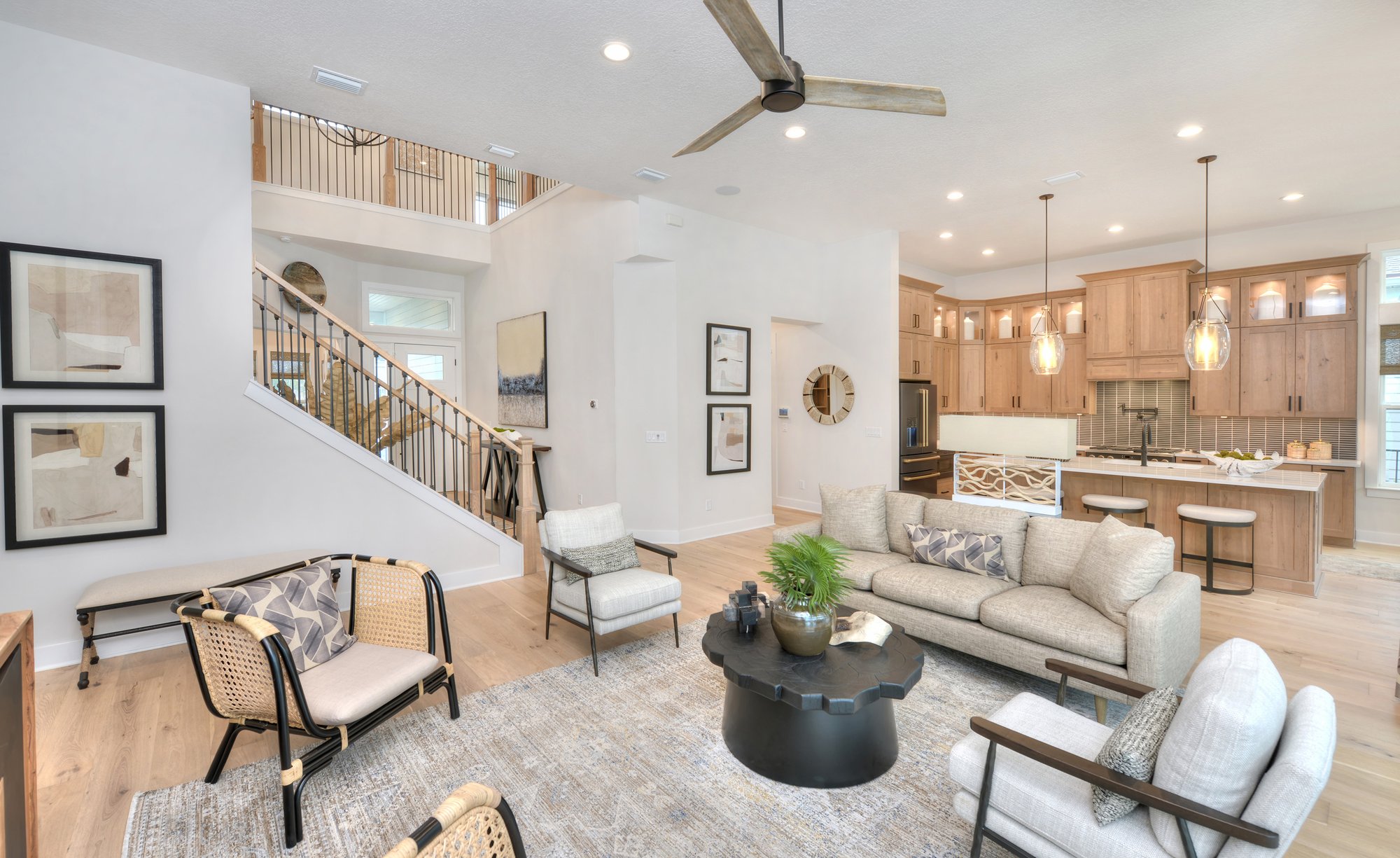 Living Room interior with a view of the tan and white kitchen